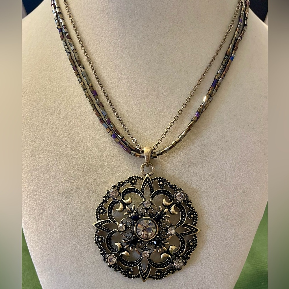 Cookie Lee 3 strand Necklace with Ornate Filigree Pendant. 15 inches long